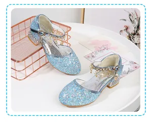 Detail of blue sequined princess shoes featuring hanging metal star charms and glitter finish