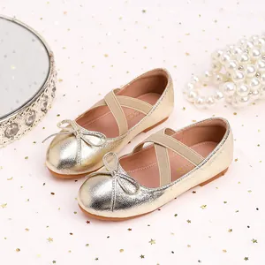 Golden girls princess shoes with bow detail and elastic straps on sparkling background