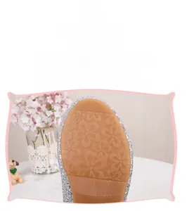 Detailansicht der abriebfesten Gummisohle mit Blumenprofil an silbernen Glitzerschuhen