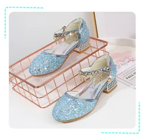Close-up of glittery blue princess shoes with silver trim and star charm detailing