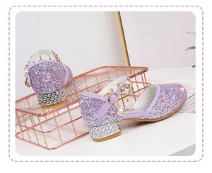 Detail of purple sequin Mary Jane shoes with rhinestone block heels and star moon charms