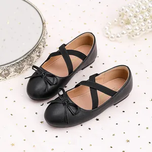Girls black ballet flats with bow and cross straps on elegant star tulle background