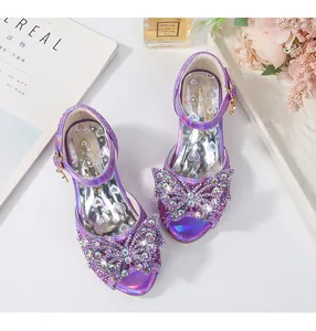 Lifestyle overhead shot of purple sequined girl's sandals with rhinestone bows