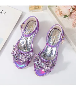 Detailed view of purple glitter girls' sandals with large rhinestone butterfly bow