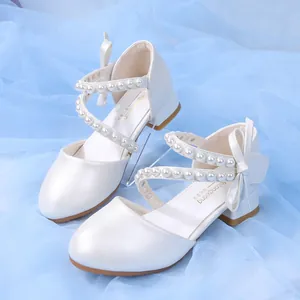 Pearlescent white girls princess shoes with pearl straps and a satin bow decoration