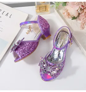 Detailed view of purple glitter girl high heels with rhinestone butterfly and moon charm