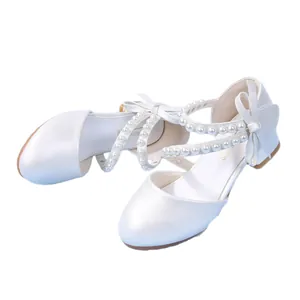 Girl's pearl white princess shoes with decorative bow and elegant beaded cross straps