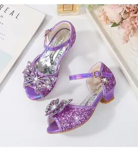 Detail of purple glitter girl sandals with rhinestone bow and block high heels