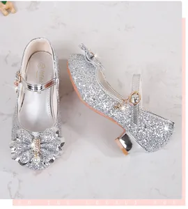 Dettaglio delle scarpe Mary Jane glitterate argento con fiocco di strass e paillettes