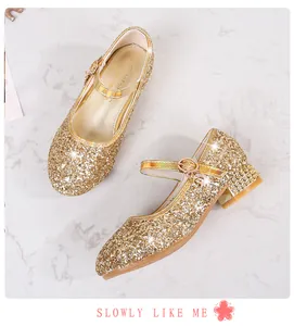 Nahaufnahme von goldenen Pailletten-Mary-Janes für Mädchen mit Strassabsätzen und Schnallen