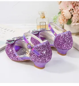 Detailed view of girls' purple sequin princess shoes with rhinestone bow and heart charm