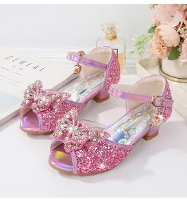 Detailed macro view of pink girls' princess sandals with sparkly sequins and bow