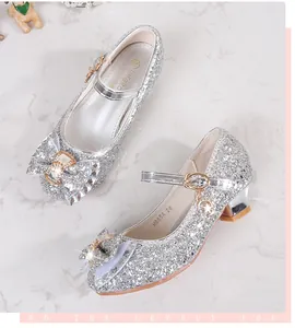 Detail of silver sequin Mary Jane shoes with bow decoration and star charm for girls