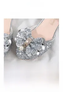Close-up of silver sequin girl princess shoes featuring handcrafted flower and pearl detail