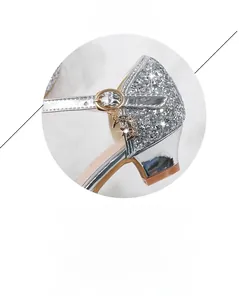 Detail of silver sequin girls princess shoe with gold moon star pendant and buckle
