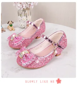 Detail of pink sequin Mary Jane shoe with rhinestone bow and polished metal buckle