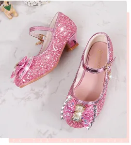 Close-up of pink sequined girls' shoes with sparkling rhinestones and a silk bow