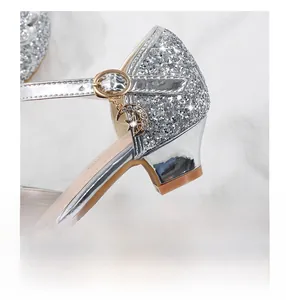Detail of girls silver sequin dress shoes with starry charms and comfy block heels
