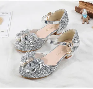 Detail of silver sequined girls princess shoes with pearl flower and star pendant