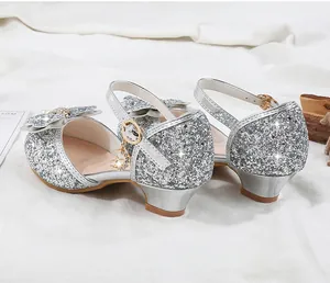 Close-up of girls silver sequin princess shoes with glitter bow and moon charms