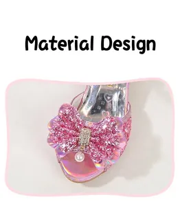 Close-up of pink sequin bow with rhinestone and pearl on children princess shoe