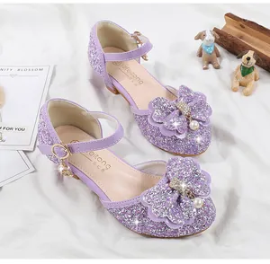 Close-up of girls' purple sequin princess shoes with double bow and pearl heart charm
