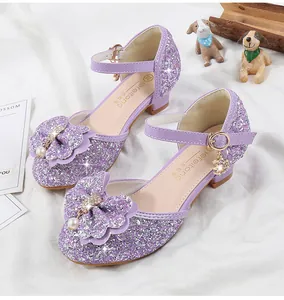Detailed macro shot of purple sequined girls princess shoes with large bow and rhinestones