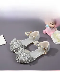 Detailed view of silver sparkly girls princess sandals with large mesh bow and pearl strap