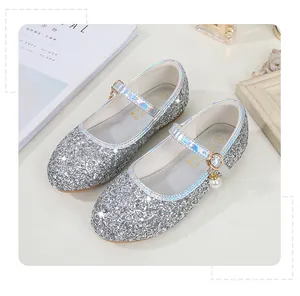 Detail of silver sequin Mary Jane shoes with holographic strap and pearl charm