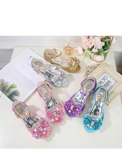Flat lay of sparkly princess sandals for girls with bow details and pearl accents
