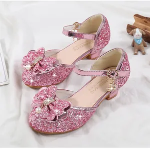 Detail of pink sequin Mary Jane shoes with rhinestone bow and moon charm