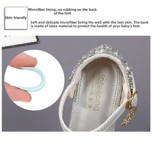 Detail of silver sequin princess shoe showing blue latex arch support and soft lining