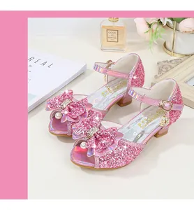Close-up of pink glitter girl princess sandal with sequin bow and pearl charm detail