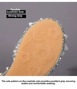 Detail of non-slip rubber sole with floral patterns and silver glitter for girls sandals