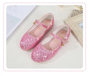 Close-up of pink sequin Mary Jane shoes with pearl pendant and glittery buckle