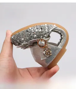 Close-up of flexible silver sequin girl sandals showing soft rubber sole and durability