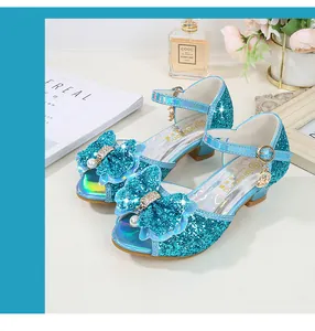 Macro detail of blue sequin girls princess sandals with pearl bow and moon charm