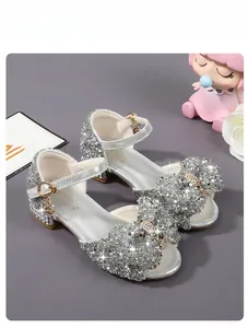 Detail of silver sequin girls princess shoes with bow ornament and crystal glitter