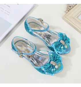 Detail view of blue sequin girls princess shoes with large bow and pearl pendant