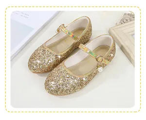 Close-up of girls' golden sequin Mary Jane shoes with pearl pendant and buckle detail