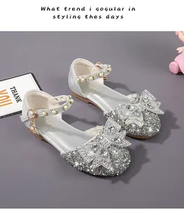 Macro detail of silver girls princess shoes with sparkling sequins and rhinestone bowknot