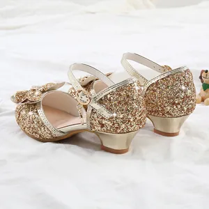 Detail view of champagne gold sequined princess shoes with a bow and low block heel