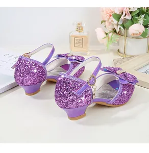Close-up of girls purple sequin dress shoes with rhinestone bow and ankle strap