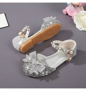Detail of silver sequin girls princess shoes with rhinestone bow and pearl strap
