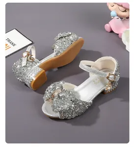 Detail of silver sparkling girls princess sandals with sequined bow and buckle charm
