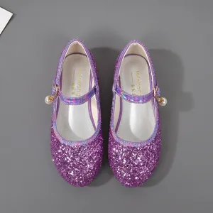 Detail view of purple sequin girls' Mary Jane shoes with pearl and bell charms