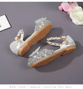 Detail of silver sequin princess shoes with pearl strap and bow for girls party wear