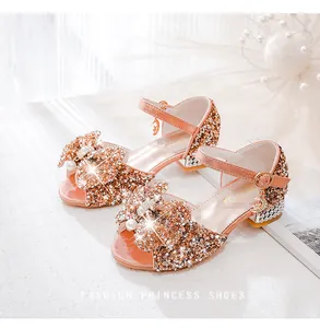 Detail of girl's princess sandals with champagne sequins, pearls and star pendant