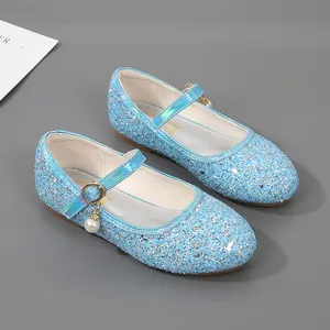 Detail of light blue sequin girls Mary Jane shoes with pearl charm and metallic buckle