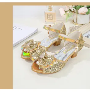 Detailed view of girls gold sequin high heel sandals with pearl bow and laser finish